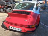 a red and white car parked in a parking lot