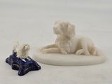 figurine of a dog and a cat sitting on a pillow