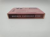 a close up of a box of brown espresso eyes on a white surface