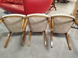 four chairs are lined up in a row in a room