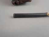 a pen that is sitting on a table next to a figurine