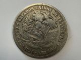 a close up of a silver coin on a white surface