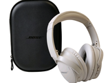 a pair of headphones sitting next to a carrying case