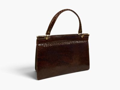 a brown snake skin handbag on a white background