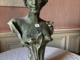 a statue of a woman that is sitting on a table