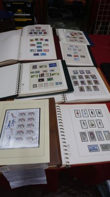 a lot of books on a table with a lot of stamps on them
