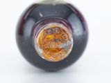 a close up of a bottle of wine on a white surface