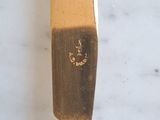 a knife that has a gold handle on it