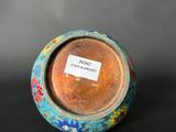 a small vase with a label on it