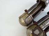two old metal objects that are on a white surface