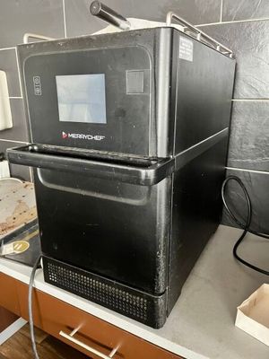 a black microwave sitting on top of a kitchen counter