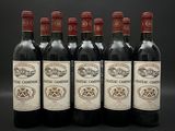 six bouteilles de vin sont alignées sur une surface noire