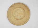 a brown plate on a white surface with a white background