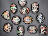 six pieces of glass with different designs on them on a black surface