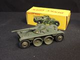 a toy tank that is on a table next to a box