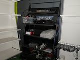 a shelf with a bunch of electronics on it in a room