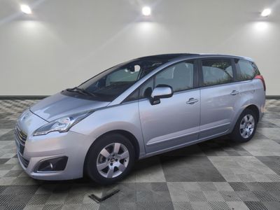 a picture of a silver minivan parked in a garage