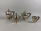 a group of silverplated tea and coffee pots