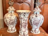 three vases that are sitting on a wooden table