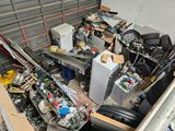 a pile of assorted electronics in a storage area