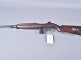 an old gun with a wooden handle and a tag on it