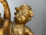 a gold figurine of a boy and a girl