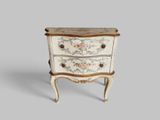 a small chest of drawers with a floral design on it