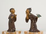pair of bronze figurines of a woman with a fan and a fan