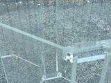 a glass table with a glass top on a gravel ground