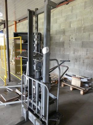 a forklift in the middle of a warehouse with pallets on the floor