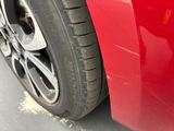 a close up of a car ' s tire on the road