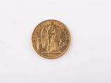 an old gold coin on a white surface with a white background