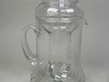a clear glass teapot with a lid on a table