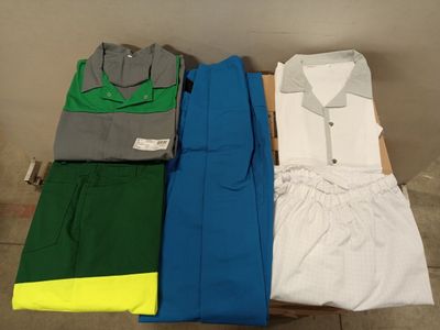 three men ' s shirts and pants laid out on a table