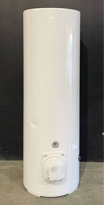 a white water heater sitting on the floor next to a black wall