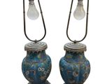 pair of blue and gold vases with a light bulb on top