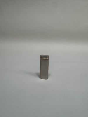 an image of a small metal object on a white surface