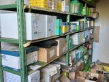 boxes and boxes are stacked on a shelf in a room