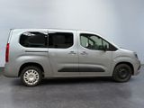 the silver van is parked on the concrete floor in the room