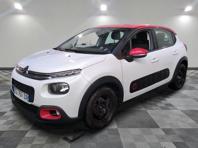a white and red citrole car parked in a garage