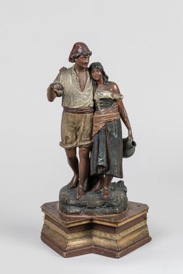 statue of a man and a woman standing on a pedestal