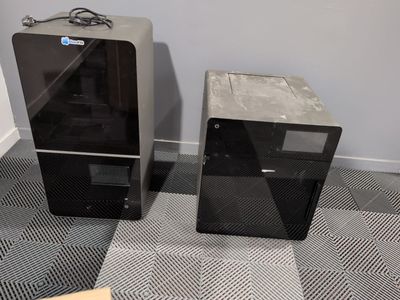 two speakers sitting next to each other on the floor