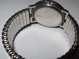 a close up of a wrist watch on a white surface