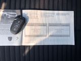 a car key sitting on top of a piece of paper in the back seat of a car
