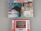 a small electronic game that is sitting next to a box