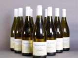 six bottles of wine are lined up in a row on a table