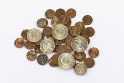 a pile of coins on a white surface