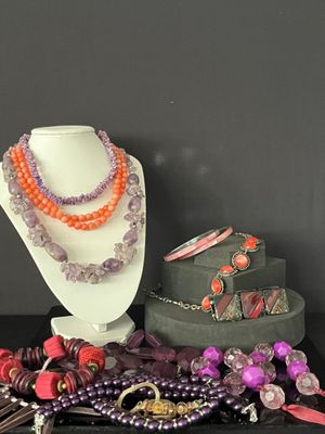 a display of jewelry on a table with a black background