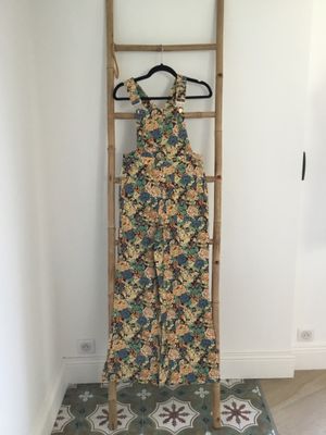 a dress hanging on a wooden ladder in a room