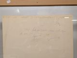 a piece of paper with writing on it in a glass case